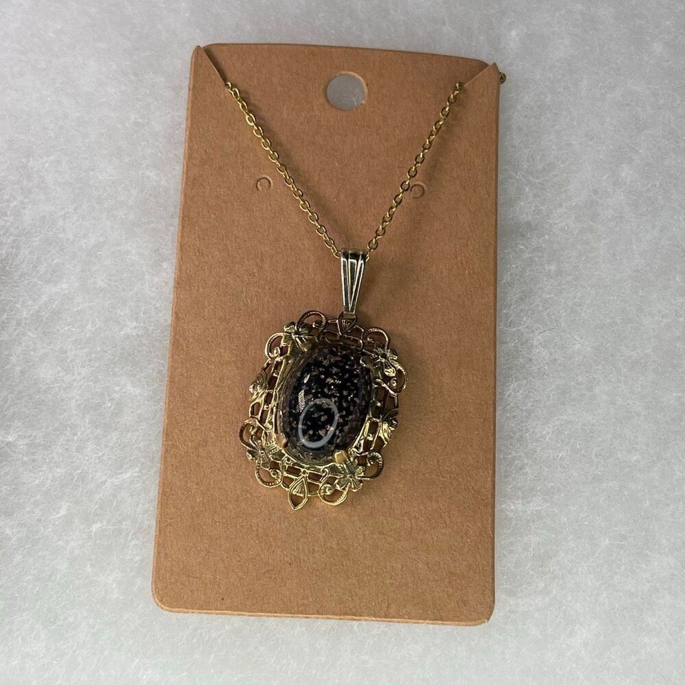 Vintage filigree black clear goldstone necklace.